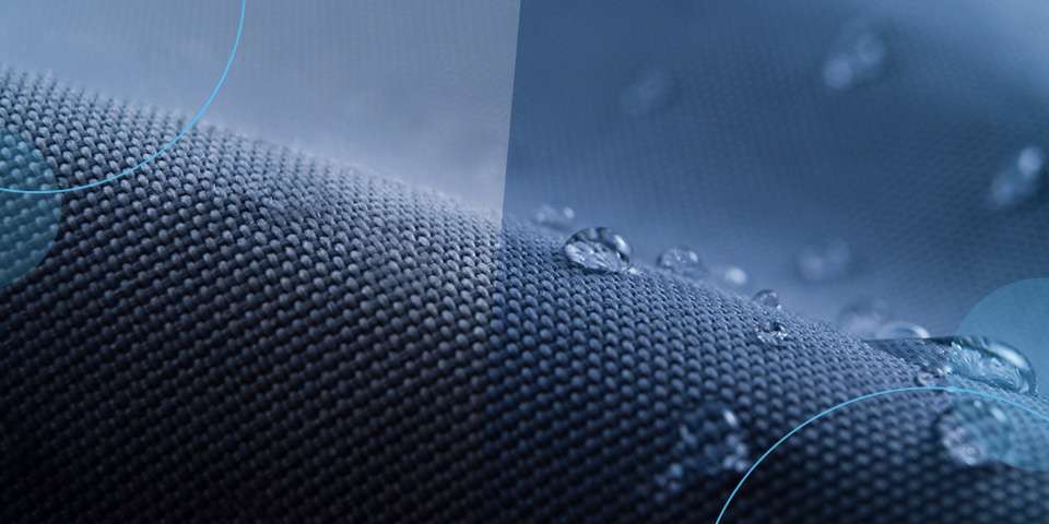 A dark piece of wavy fabric with water droplets sitting on top
