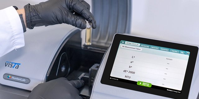 Taking the energy drink sample out of the Vista spectrophotometer