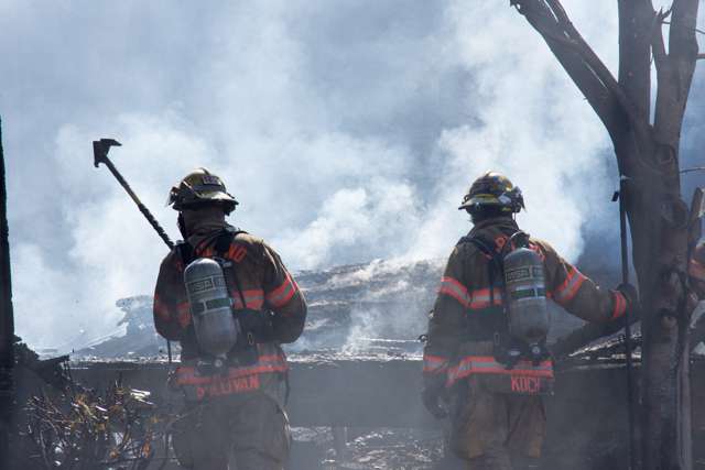 Two firefighters wearing high-visibility safety clothing