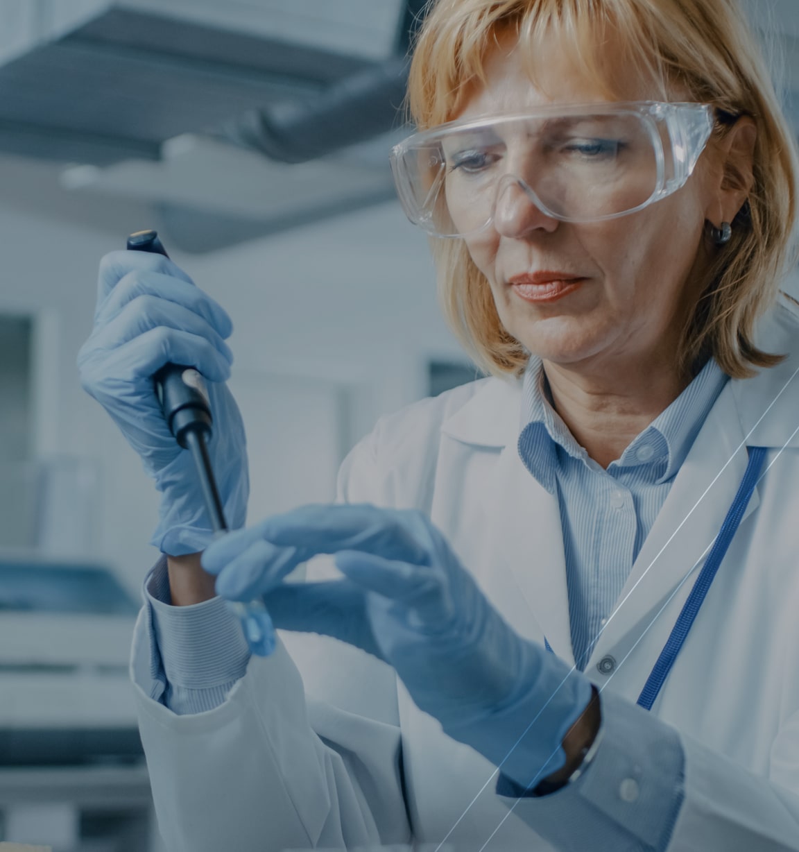 Lab technician analyzing a blue liquid sample in a beaker